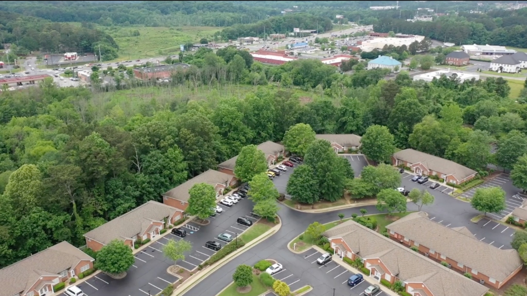 Aerial drone view of the Creekstone Ridge office park in Woodstock, Georgia — Premier Executive Suites virtual office campus at 225 Creekstone Ridge, Woodstock GA 30188, surrounded by mature trees 30 miles north of Atlanta
