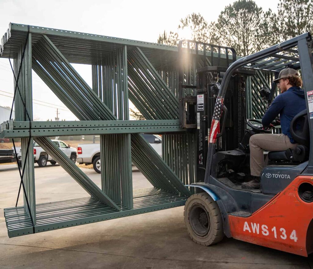 AWS installation crew loading pallet racking components onto a forklift at a Georgia warehouse job site